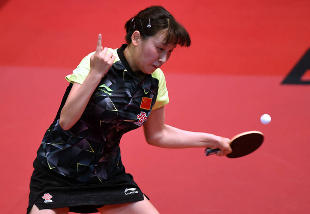 Qian Tianyi of China returns a shot to Soma Yumeno of Japan in their Junior Girls Singles match during the 2017 ITTF World Junior Circuit Hong Kong Junior and Cadet Open at Queen Elizabeth Stadium in Hong Kong, China, 5 August 2017 - Фото, изображение