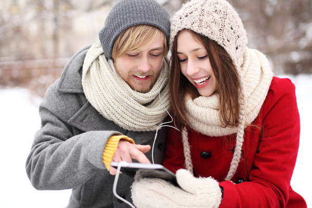 Winter couple with digital tablet - Photo, Image