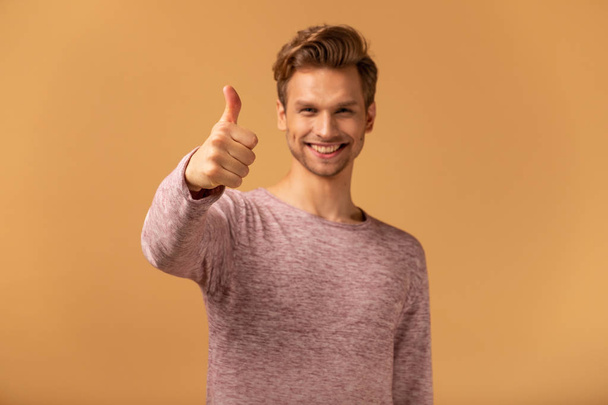 Young man in casual style showing OK sign on orange background - 写真・画像