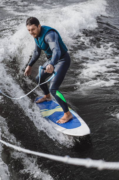 man on wakesurfing. wave from the boat. - Foto, Bild