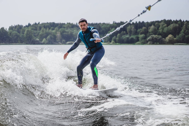 man on wakesurfing. wave from the boat. - Zdjęcie, obraz