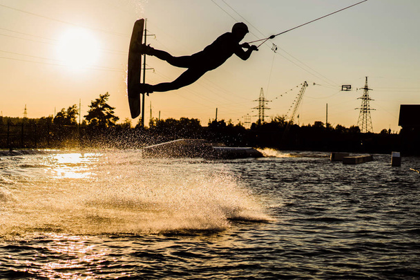 wakeboard. wakeboarding jumping at sunset - Photo, image