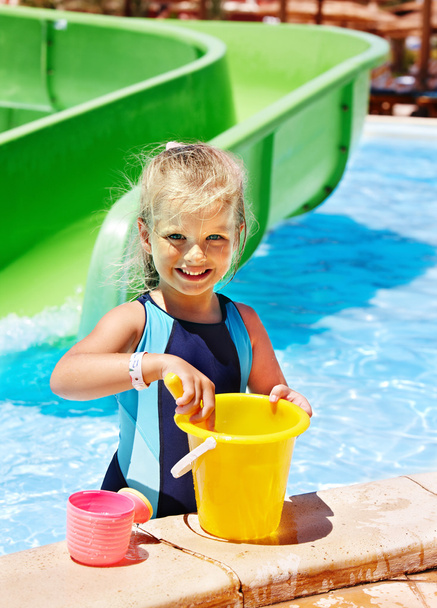 Child with bucket in swimming pool. - Photo, Image