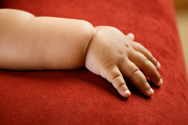 Children's hand isolated on red background - Photo, image