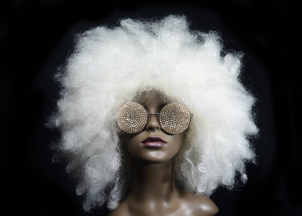 Mannequin with sunglasses and wig on black background - Zdjęcie, obraz