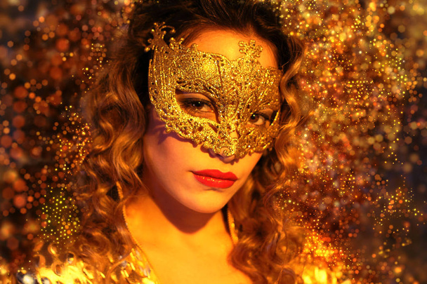 Portrait of woman in golden carnival mask  - Photo, Image