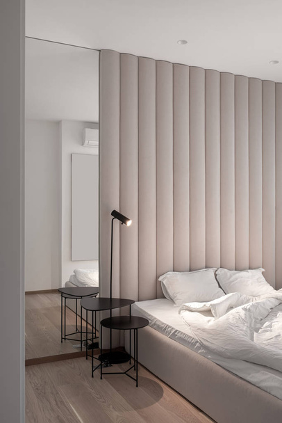 Stylish bedroom in modern style with brown textile wall panel - Foto, immagini
