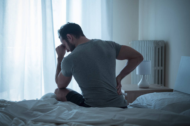Man waking up in the morning and suffer for back pain - Photo, image