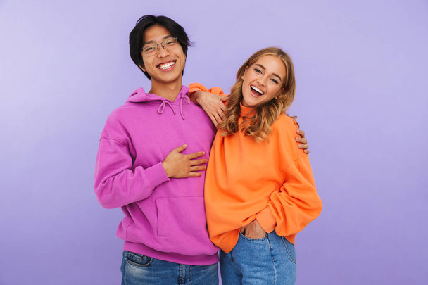 Photo of happy young couple friends students standing isolated over white wall background. - Foto, afbeelding