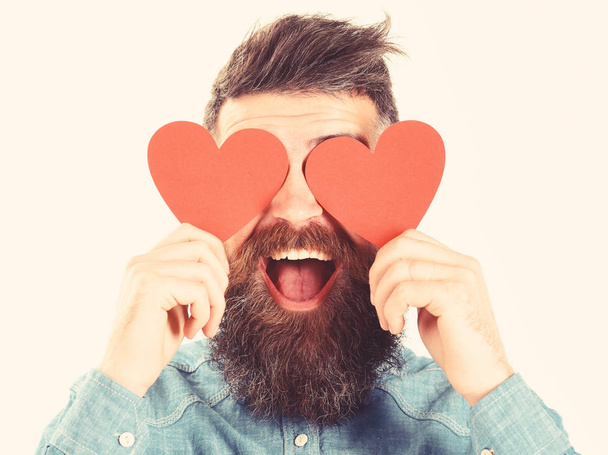 Blinded by love concept. Man with beard holds red hearts - Foto, Imagem