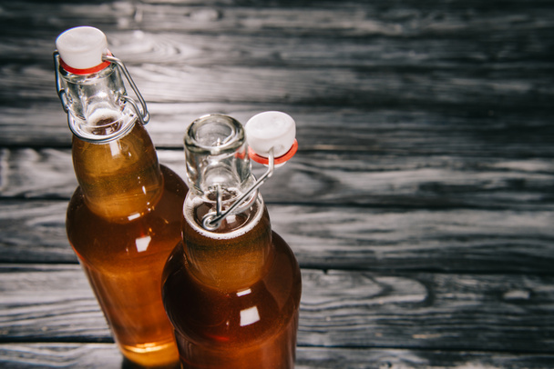 fermented tea in glass bottles on wooden table - Foto, Imagem