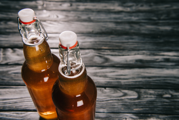 studio shot of fermented tea in glass bottles with sunlight - Фото, зображення