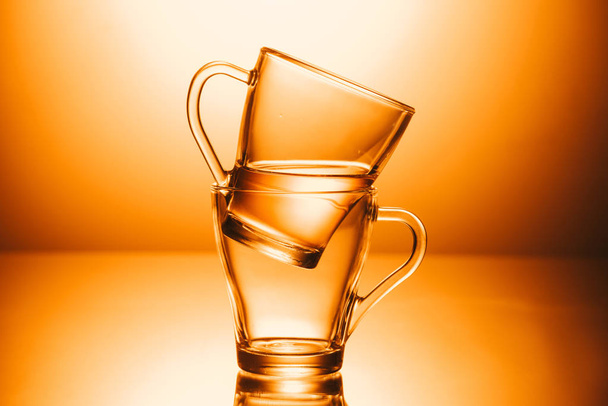 selective focus of two cups of tea on orange background - Foto, Bild