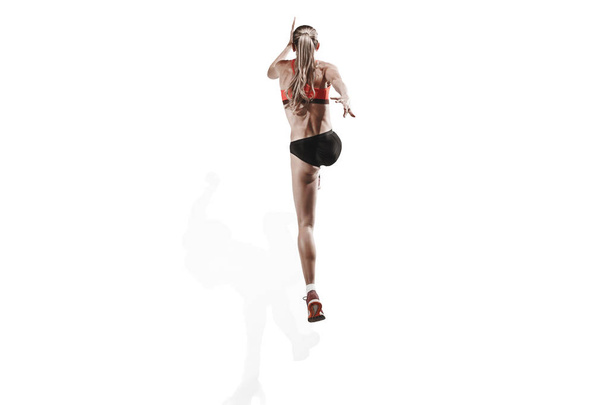 one caucasian woman running on white background - Foto, afbeelding