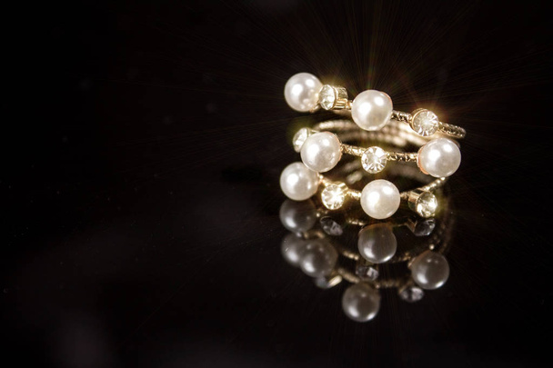 ring with pearls and diamonds on black background - Fotografie, Obrázek