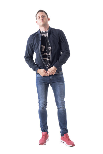 Serious macho adult casual man getting dressed zipping bomber jacket. Full body isolated on white background.  - Foto, Imagem