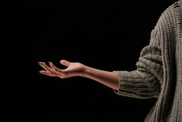 cropped view of woman in knitted sweater isolated on black - Foto, Imagem