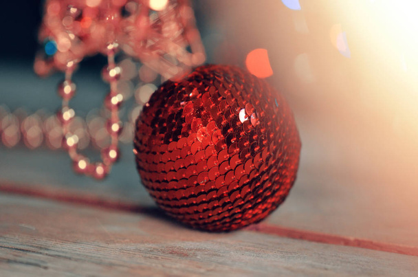 Red bauble on Christmas tree. Decorated Christmas tree. Red decorative ball on Christmas tree  - Photo, Image