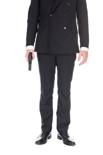 cropped view of killer in black suit holding handgun, isolated on white - Foto, immagini