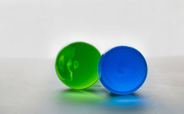 Two glass spheres close up on a light background. - Valokuva, kuva