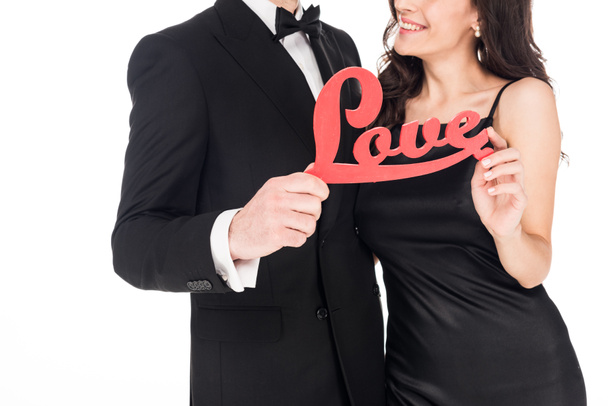 cropped view of happy couple holding red love sign on valentines day, isolated on white - Foto, immagini