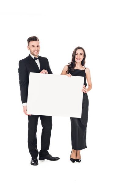 beautiful elegant couple in black clothes holding blank board, isolated on white - Photo, Image