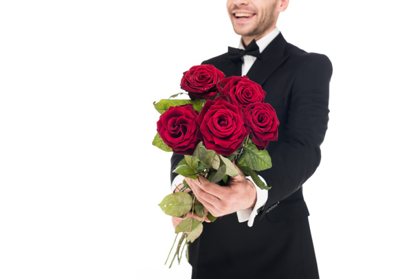 cropped view of happy man gifting red roses for valentines day, isolated on white - Photo, Image
