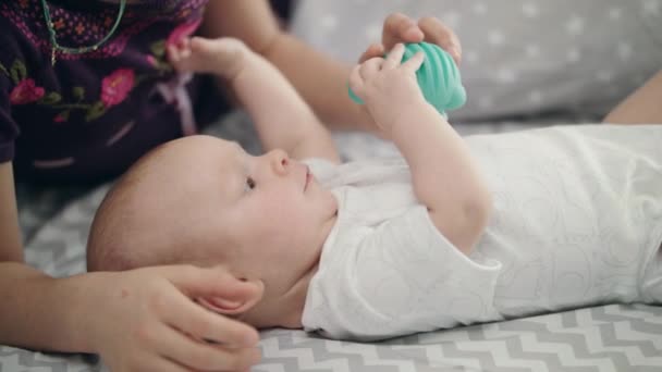 Cute baby holding blue toy. Newborn kid development. Lovely child study world - Footage, Video