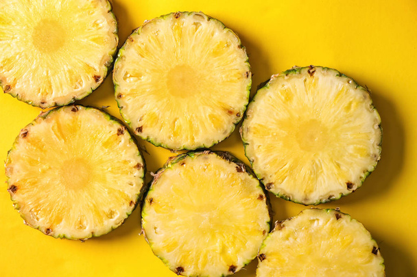 Juicy pineapple slices on color background - Фото, изображение