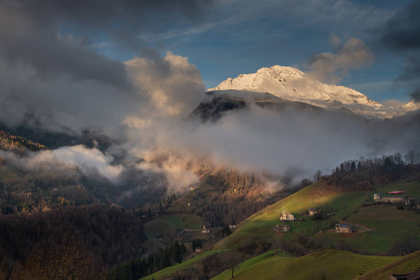 the snowy mountain arera appears from the clouds - Photo, Image