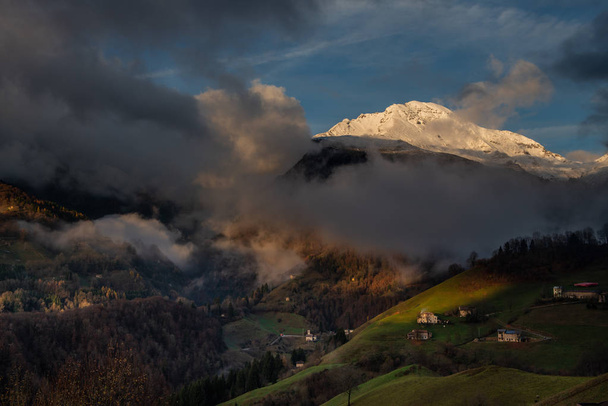 the snowy mountain arera appears from the clouds - Photo, Image