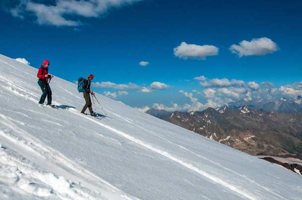 tourists in the snowy Caucasus mountains in July - Photo, Image