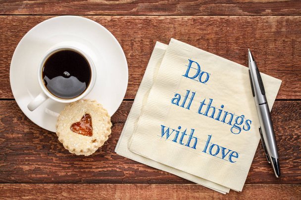 do all things with love - handwriting on a napkin with a cup of coffee and heart biscuit cookie - Фото, изображение