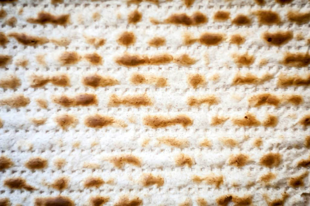 Jewish traditional Matso unleavened bread textured background, matso bread is made during the Jewish Passover Pesach holiday. Pesach concept greeting card. - Photo, Image