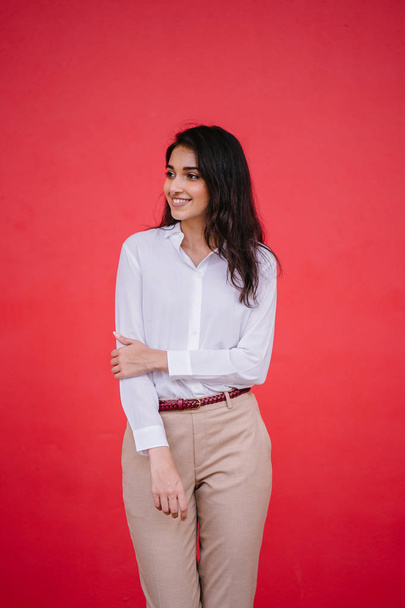portrait of a young Indian Asian girl business student dressed in a crisp white shirt and khaki pants - Фото, зображення