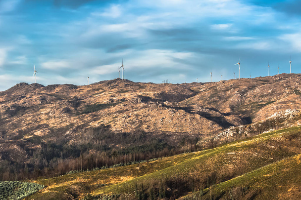 Vista de una turbina eólica en la cima de la montaña, cielo dramático como fondo, Portugal
 - Foto, imagen