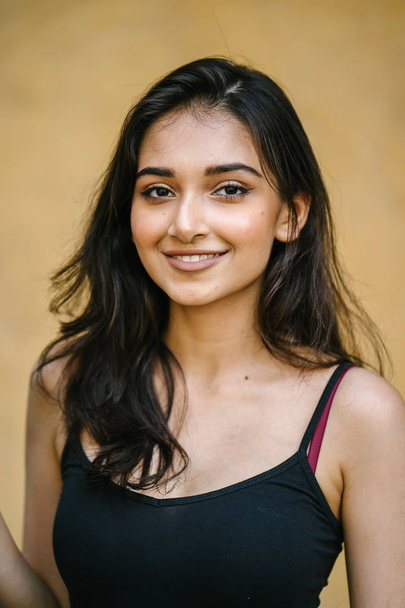 portrait of a young, attractive and beautiful Indian Asian girl in fitting black top - Foto, Imagem