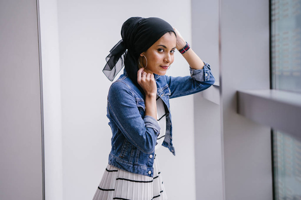 Young, elegant and attractive Malay Muslim woman wearing dress and denim jacket during the day. - Φωτογραφία, εικόνα
