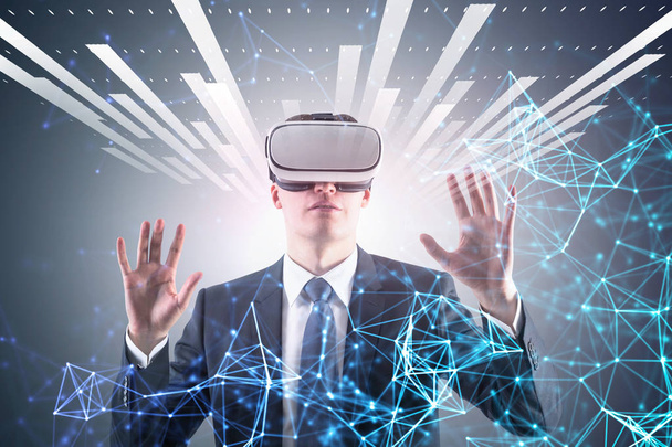 Astonished blond businessman in vr glasses standing over gray background with double exposure of immersive interface and polygons. Toned image - Foto, afbeelding