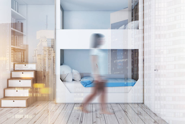Woman in interior of teenager bedroom with white walls, wooden floor, white and wooden bunk bed and white bookcase. Toned image double exposure blur - Photo, Image