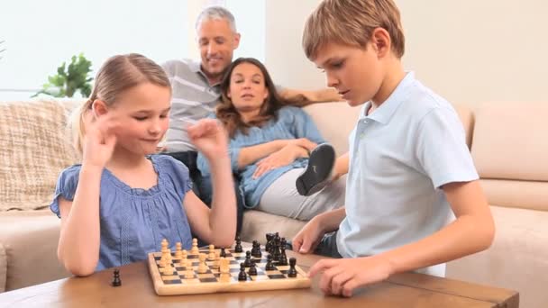 Serious siblings playing chess - Felvétel, videó