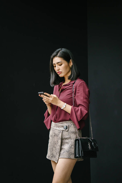 young Korean Asian woman holding smartphone  - Foto, Imagem