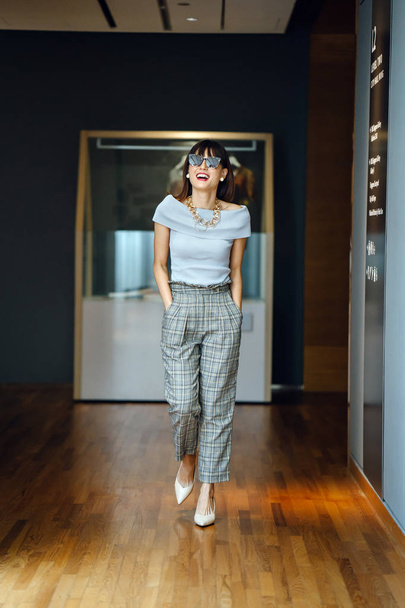 Portrait of a middle-aged, mature Asian Chinese woman in smart casual grey outfit - Fotografie, Obrázek