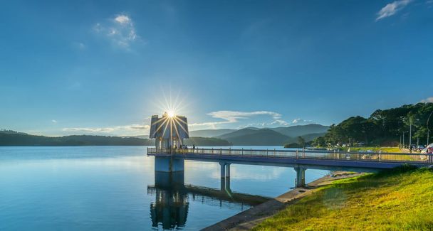 Da Lat, Vietnam - November 29th, 2018: Architectural beauty hydroelectric power with sun stars sunset sky attracting tourists to visit and photograph in Da lat, Vietnam - Fotó, kép