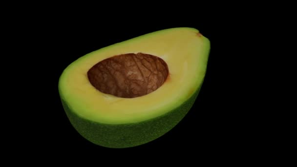 Realistické vykreslení rotujícího zeleného floridského avokáda (rozříznutého na půl) na černém pozadí. Video je hladce smyčka, a objekt je 3D skenován ze skutečného avokáda. - Záběry, video