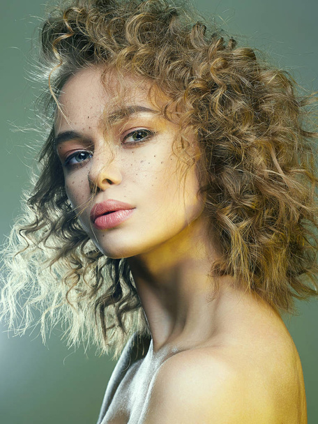 Beautiful freckles woman in green Light. amazing curly girl with make-up. beauty fashion portrait. frizzle hair - Zdjęcie, obraz