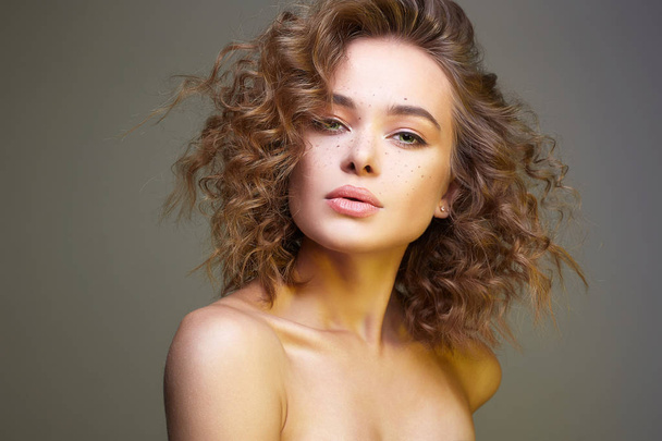 Beautiful young woman. amazing curly girl with make-up. beauty fashion portrait. frizzle hair - Photo, Image