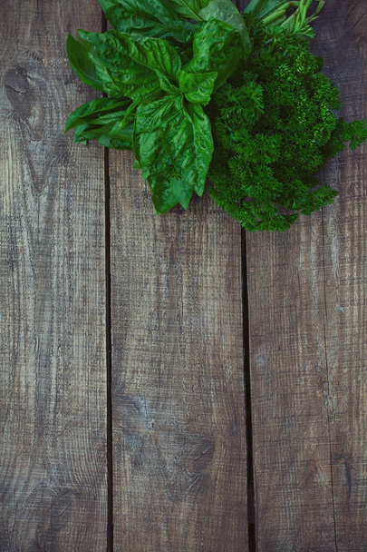 bunch of parsley and basil on wooden surface - Φωτογραφία, εικόνα