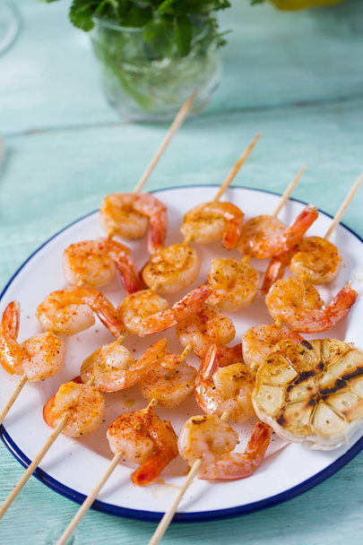 grilled shrimp skewers on wooden surface - Photo, image