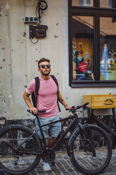 young man riding bicycle on the street - Fotografie, Obrázek